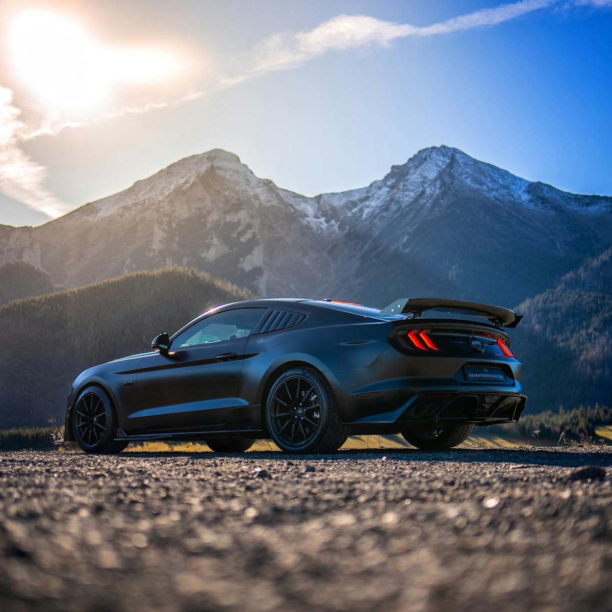 black ford mustang in mountains 1