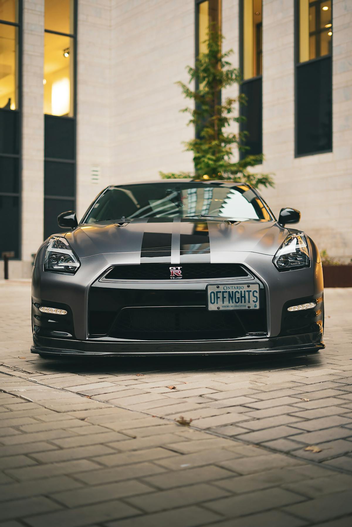 nissan gt r parked in front of a building 1